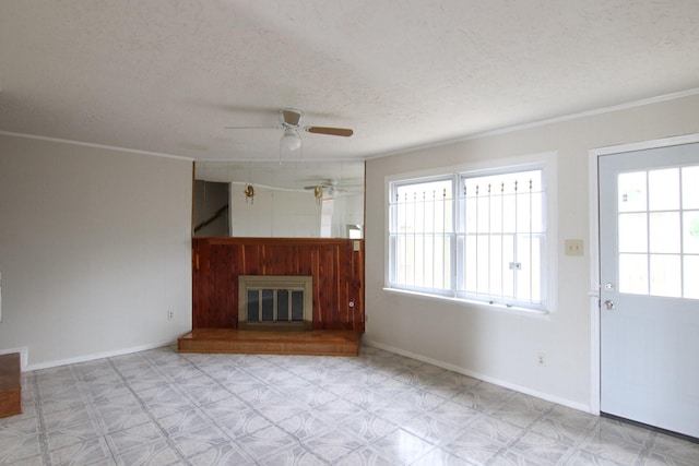 9357 Springmont Dr, Houston, TX 77080 - unfurnished living room featuring ceiling fan, a textured ceiling, tile patterned floors, ornamental molding, and baseboards