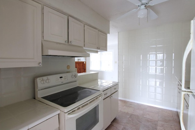 9357 Springmont Dr, Houston, TX 77080 - kitchen featuring white appliances, under cabinet range hood, tile counters, ceiling fan, and backsplash