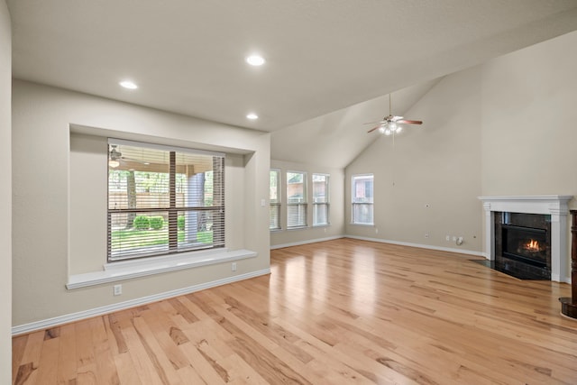 155 Pronghorn Pl, Montgomery, TX 77316 - unfurnished living room with a tile fireplace, lofted ceiling, baseboards, light wood-style floors, and ceiling fan