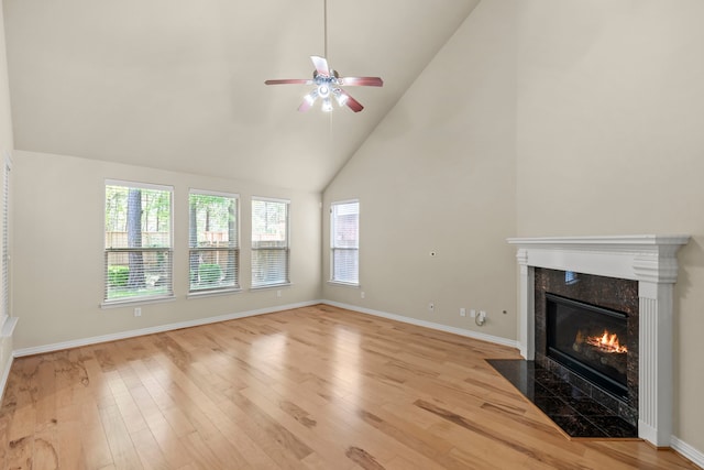 155 Pronghorn Pl, Montgomery, TX 77316 - unfurnished living room featuring baseboards, a high end fireplace, light wood-style floors, and ceiling fan