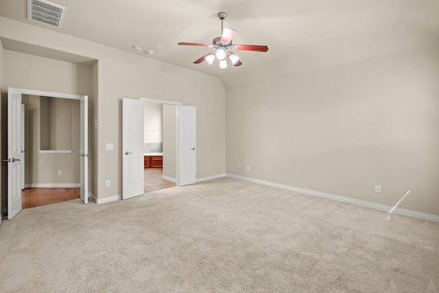 155 Pronghorn Pl, Montgomery, TX 77316 - unfurnished bedroom featuring vaulted ceiling, light colored carpet, baseboards, visible vents, and ensuite bathroom
