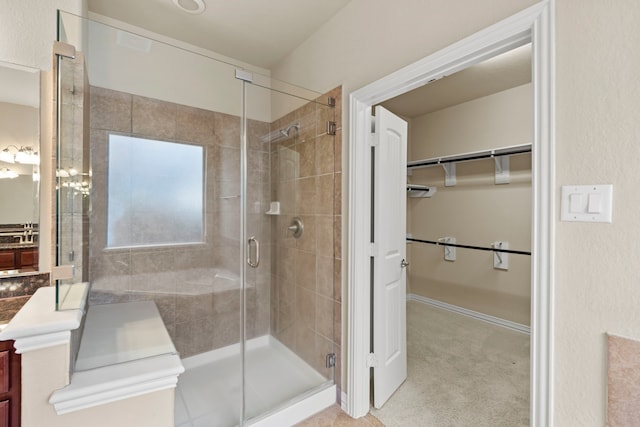 155 Pronghorn Pl, Montgomery, TX 77316 - bathroom featuring vanity, a walk in closet, and a stall shower