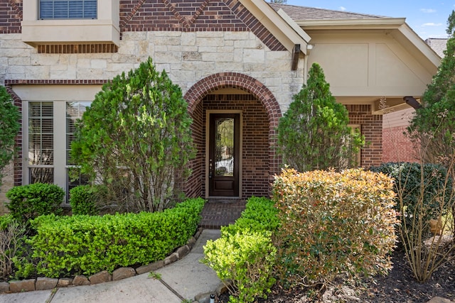 155 Pronghorn Pl, Montgomery, TX 77316 - entrance to property featuring stone siding, brick siding, a shingled roof, and stucco siding