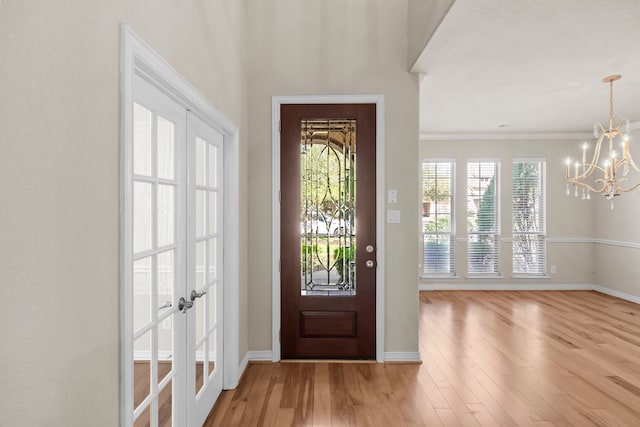 155 Pronghorn Pl, Montgomery, TX 77316 - entryway featuring baseboards, light wood-type flooring, french doors, and a chandelier