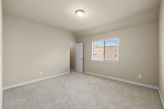 155 Pronghorn Pl, Montgomery, TX 77316 - empty room with light carpet, baseboards, and vaulted ceiling