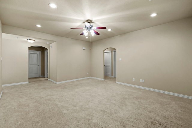 155 Pronghorn Pl, Montgomery, TX 77316 - empty room with light carpet, arched walkways, recessed lighting, and a ceiling fan