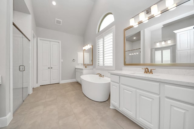 10015 Crescent Wood Dr, Missouri City, TX 77459 - bathroom featuring vanity, vaulted ceiling, a shower stall, visible vents, and a freestanding bath