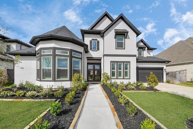view of front facade with a garage, concrete driveway, stucco siding, and fence
