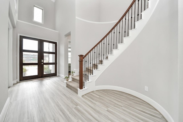 10015 Crescent Wood Dr, Missouri City, TX 77459 - entryway featuring french doors, a healthy amount of sunlight, stairs, and wood finished floors
