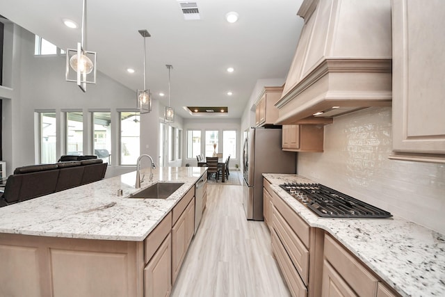 10015 Crescent Wood Dr, Missouri City, TX 77459 - kitchen with a sink, open floor plan, custom exhaust hood, stainless steel appliances, and visible vents