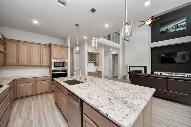 10015 Crescent Wood Dr, Missouri City, TX 77459 - kitchen featuring open floor plan, a sink, appliances with stainless steel finishes, and visible vents