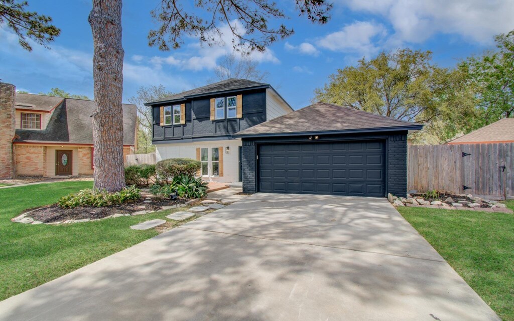 10406 Golden Meadow Dr, Houston, TX 77064 - view of front of home with concrete driveway, fence, a front yard, a garage, and a shingled roof