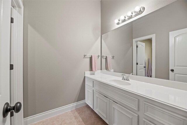 bathroom featuring tile patterned floors, vanity, and baseboards