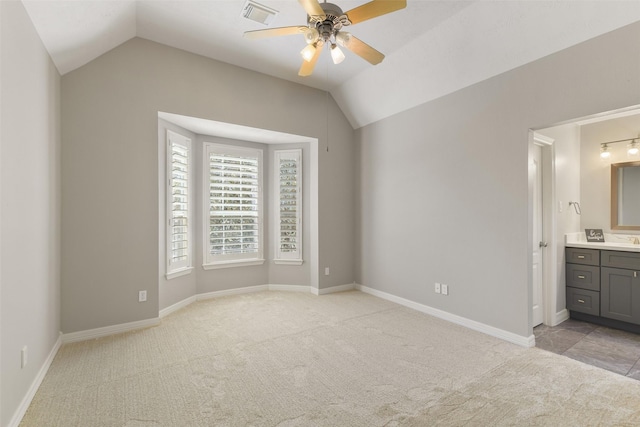 17310 Calico Peak Way, Cypress, TX 77433 - unfurnished bedroom featuring light carpet, vaulted ceiling, connected bathroom, baseboards, and a ceiling fan