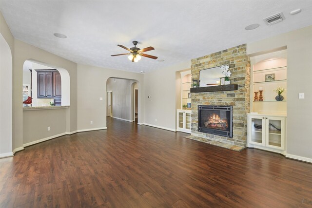 17310 Calico Peak Way, Cypress, TX 77433 - unfurnished living room with wood finished floors, ceiling fan, baseboards, a stone fireplace, and built in shelves