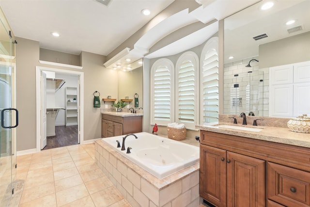 17310 Calico Peak Way, Cypress, TX 77433 - bathroom featuring a shower stall, two vanities, a jetted tub, tile patterned flooring, and recessed lighting