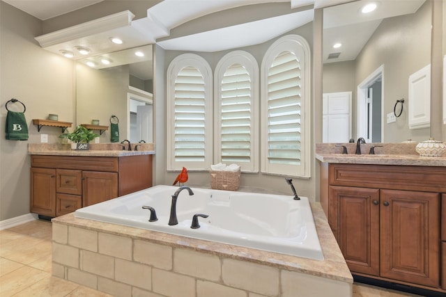 17310 Calico Peak Way, Cypress, TX 77433 - full bathroom featuring two vanities, a bath, tile patterned flooring, recessed lighting, and baseboards