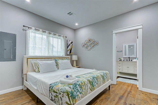 1079 Johnson Rd, Gilchrist, TX 77617 - bedroom with electric panel, hardwood / wood-style floors, baseboards, and recessed lighting