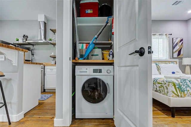 1079 Johnson Rd, Gilchrist, TX 77617 - clothes washing area featuring washer / dryer and wood finished floors