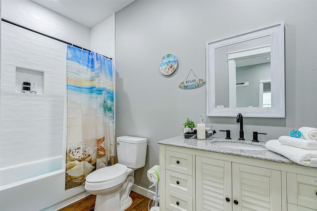 1079 Johnson Rd, Gilchrist, TX 77617 - full bathroom featuring toilet, wood finished floors, vanity, and shower / tub combo