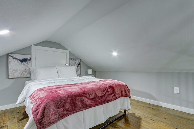 1079 Johnson Rd, Gilchrist, TX 77617 - bedroom featuring baseboards, wood-type flooring, and vaulted ceiling