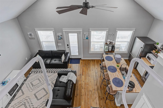 1079 Johnson Rd, Gilchrist, TX 77617 - living room with ceiling fan, wood finished floors, and high vaulted ceiling