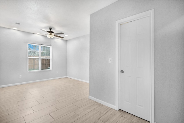22727 Hawkwood Dr, Spring, TX 77373 - spare room featuring baseboards, wood tiled floor, and a ceiling fan