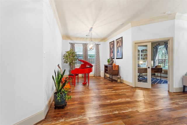 dining room featuring baseboards, wood finished floors, french doors, and crown molding