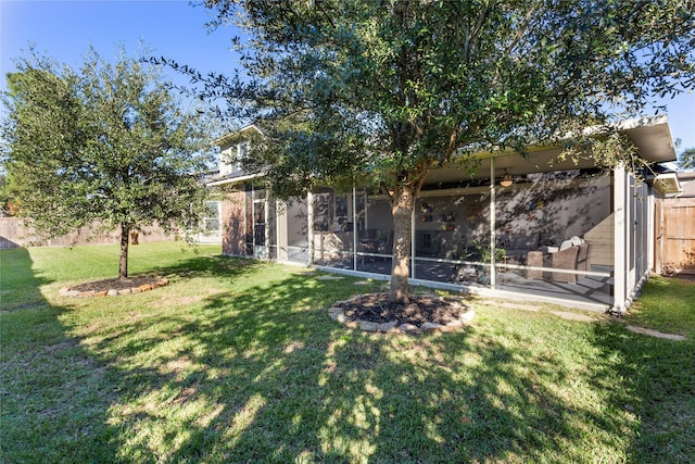 view of yard featuring a sunroom and fence