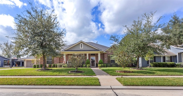 view of front facade featuring brick siding, a front yard, concrete driveway, and an attached garage