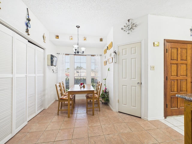 13523 Pasa Robles Ln, Houston, TX 77083 - dining room with a textured ceiling, a notable chandelier, and light tile patterned floors