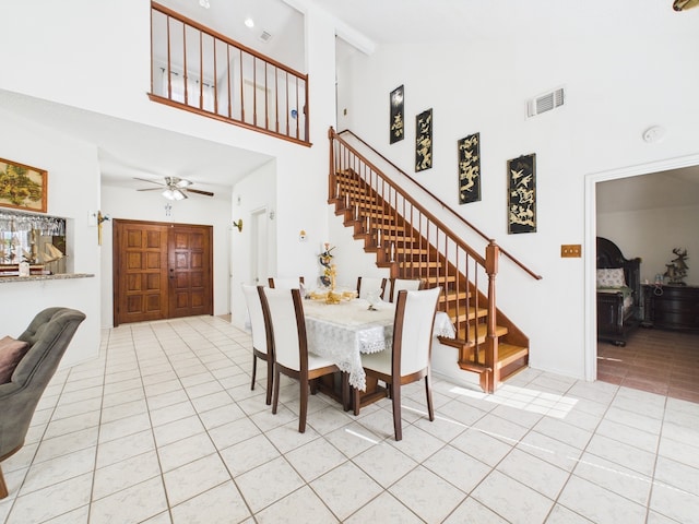 13523 Pasa Robles Ln, Houston, TX 77083 - dining room with high vaulted ceiling, visible vents, stairs, a ceiling fan, and light tile patterned floors