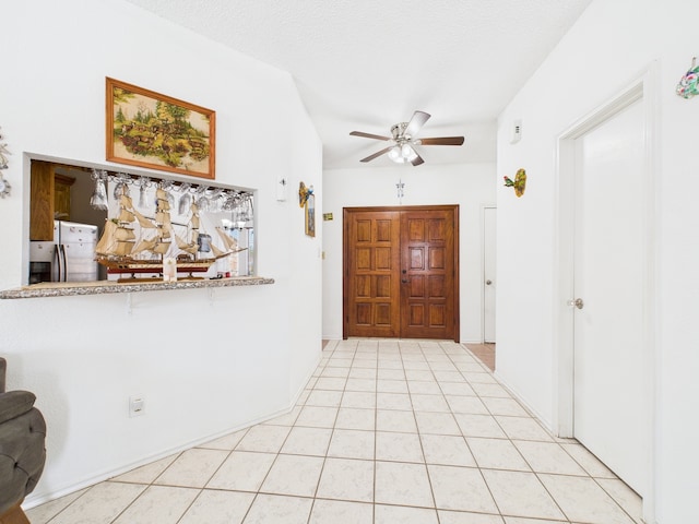 13523 Pasa Robles Ln, Houston, TX 77083 - entrance foyer with light tile patterned flooring, a textured ceiling, and ceiling fan