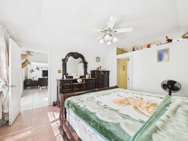 13523 Pasa Robles Ln, Houston, TX 77083 - bedroom featuring a textured ceiling, lofted ceiling, ceiling fan, and light tile patterned floors