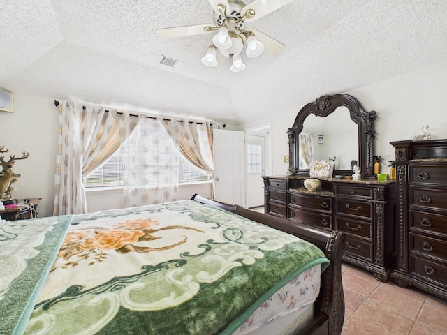 13523 Pasa Robles Ln, Houston, TX 77083 - bedroom featuring light tile patterned flooring, lofted ceiling, a textured ceiling, and visible vents