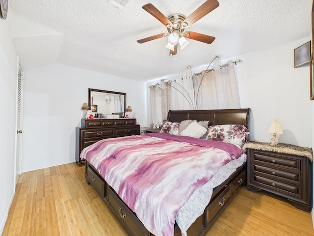 13523 Pasa Robles Ln, Houston, TX 77083 - bedroom with a ceiling fan, a textured ceiling, lofted ceiling, and light wood-type flooring