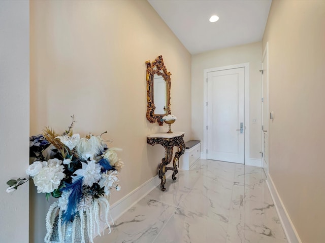 hall featuring marble finish floor, baseboards, and recessed lighting