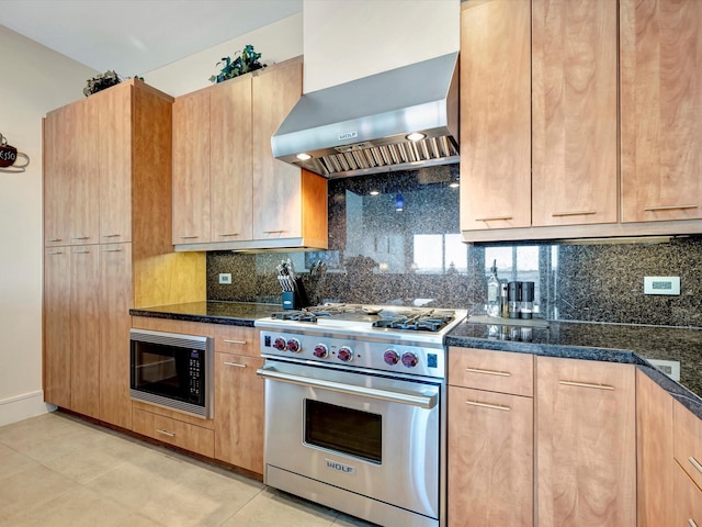 kitchen with luxury stove, wall chimney exhaust hood, decorative backsplash, and built in microwave