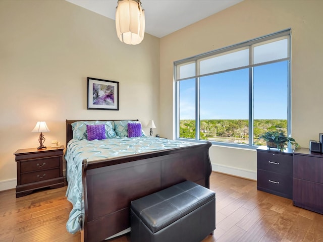 bedroom featuring baseboards and wood finished floors