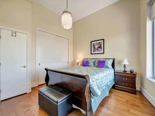 bedroom featuring baseboards and light wood-type flooring