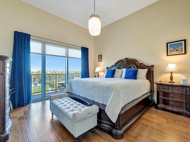 bedroom with wood finished floors and access to outside
