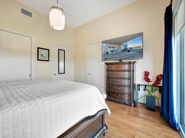 bedroom featuring light wood-type flooring and visible vents