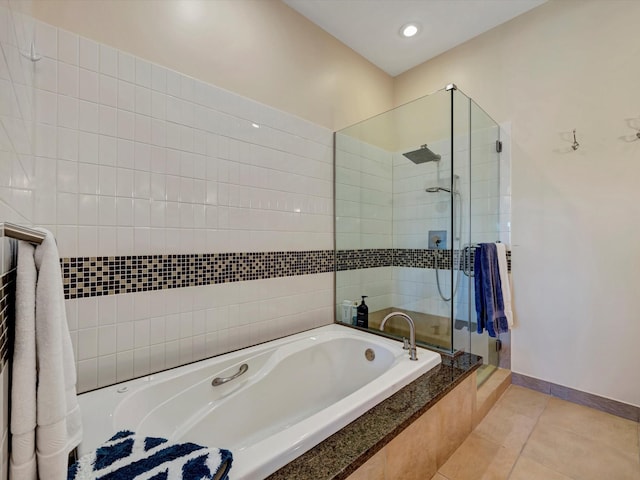 bathroom with recessed lighting, baseboards, tile patterned floors, a stall shower, and a bath