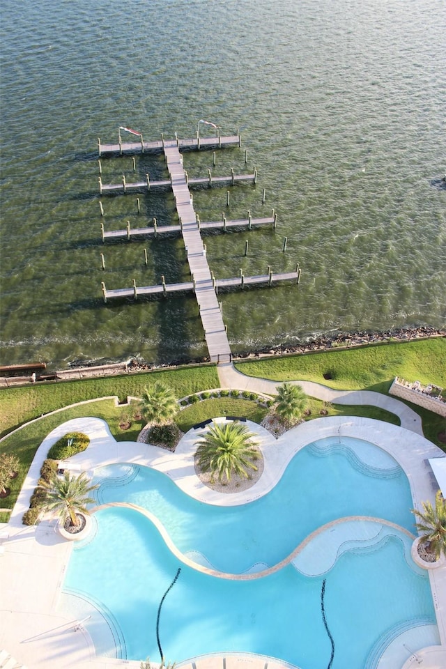 view of swimming pool with a water view and a boat dock