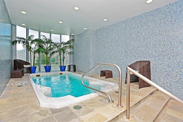 view of swimming pool featuring a hot tub