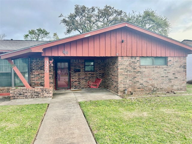 325 Hargett St, Clute, TX 77531 - single story home with brick siding, a front lawn, and board and batten siding