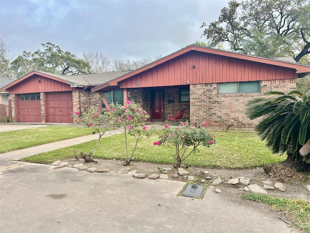 325 Hargett St, Clute, TX 77531 - view of front facade with brick siding, an attached garage, driveway, and a front yard