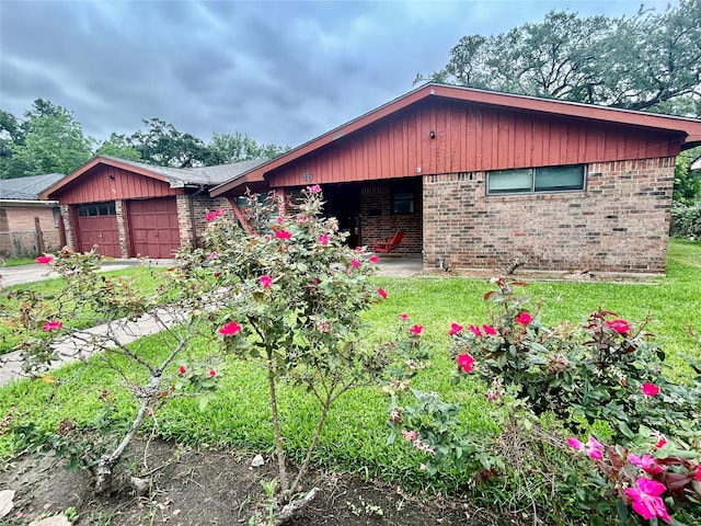 325 Hargett St, Clute, TX 77531 - view of front of house with brick siding, an attached garage, and driveway