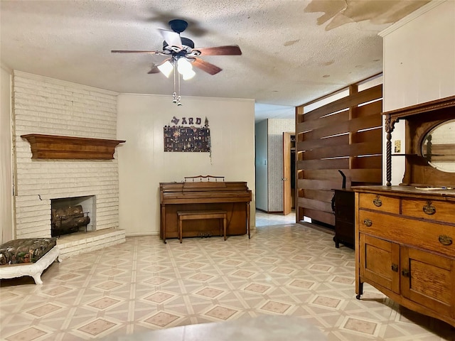 325 Hargett St, Clute, TX 77531 - living room with a ceiling fan, a textured ceiling, light floors, and a fireplace