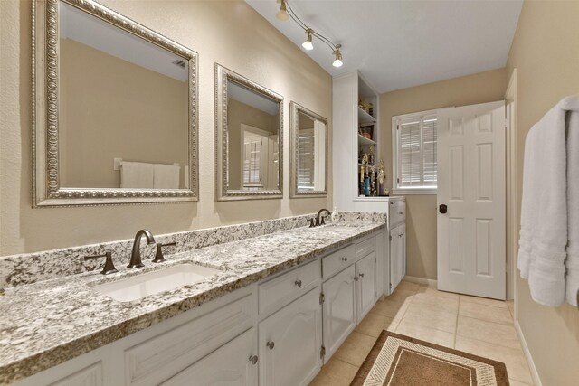 2536 22nd Ave N, Texas City, TX 77590 - full bathroom featuring tile patterned flooring, a sink, double vanity, and baseboards